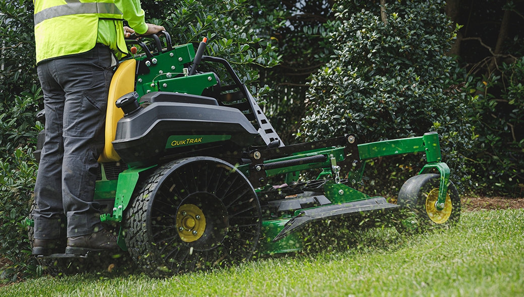 Someone mowing using the QuikTrak Q865R EFI